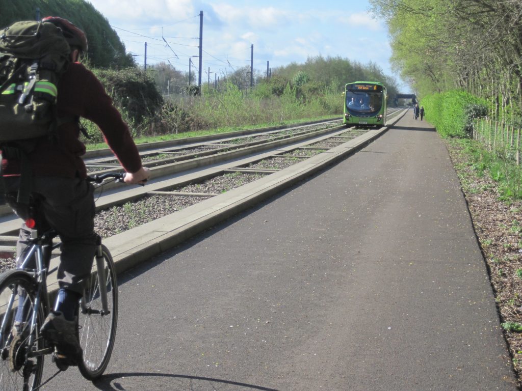 Cyclist on path next to the Cambridgeshire guided busway.